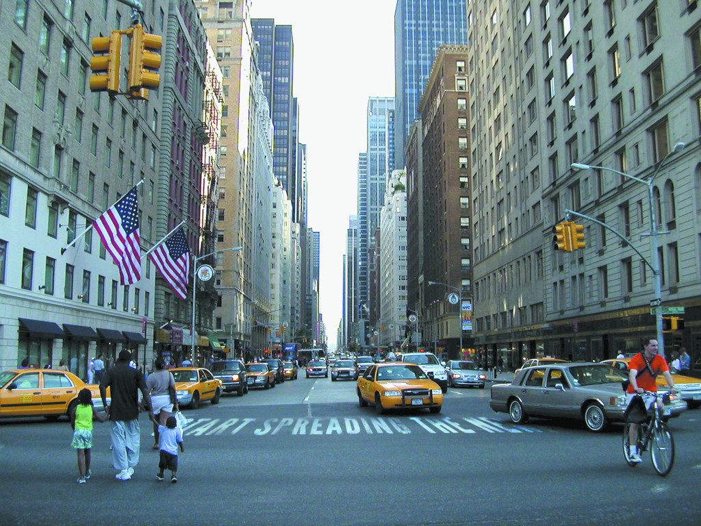 A street with cars and taxis on it