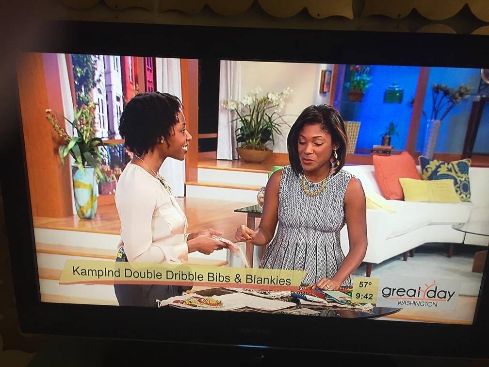 Two women are talking on a television screen.