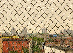 A view of the city from behind a fence.