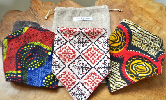 Three different patterned ties sitting on top of a table.